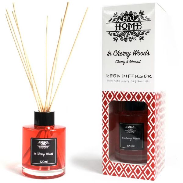 Luxury red reed diffuser with black label and natural reeds, presented beside its matching premium packaging box.