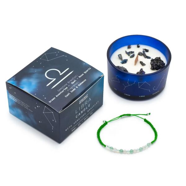 Libra Zodiac Crystal Candle in dark blue glass jar with constellation design, shown with gemstone bracelet and gift box on a white background.