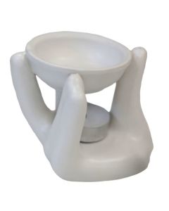 White ceramic oil burner shaped as two hands holding a bowl, designed for wax melts or fragrance oils.