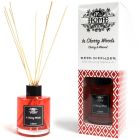 Luxury red reed diffuser with black label and natural reeds, presented beside its matching premium packaging box.